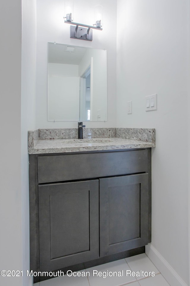 bathroom with baseboards and vanity