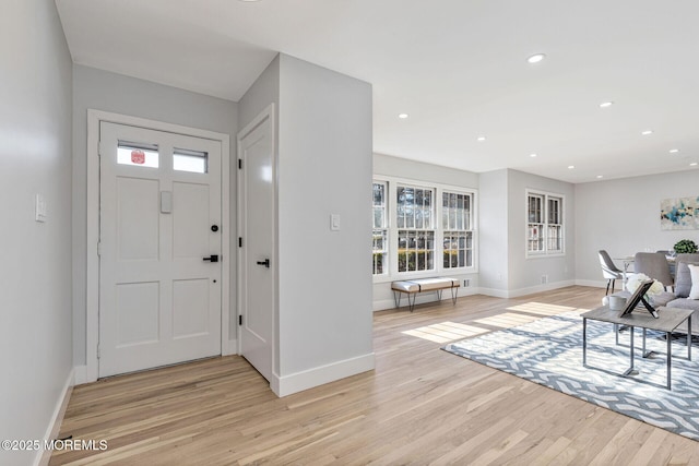 foyer entrance featuring light wood-style flooring, baseboards, and recessed lighting