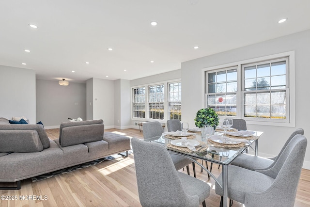 dining room featuring light wood finished floors, baseboards, and recessed lighting