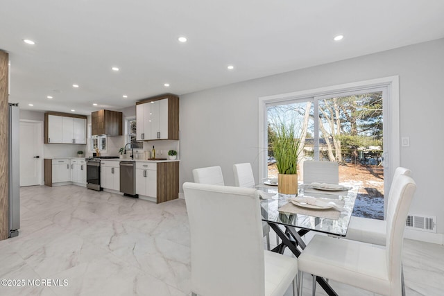 dining space with marble finish floor, visible vents, and recessed lighting