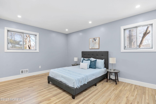 bedroom featuring recessed lighting, wood finished floors, and baseboards