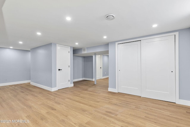 finished below grade area with baseboards, light wood finished floors, and recessed lighting