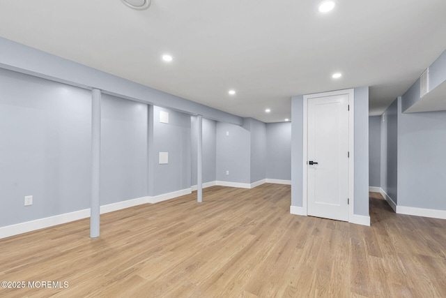 finished below grade area featuring light wood-style floors, baseboards, and recessed lighting