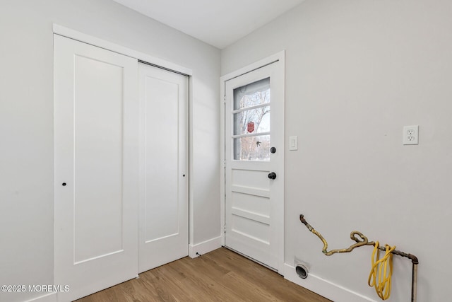 doorway to outside with light wood-style floors