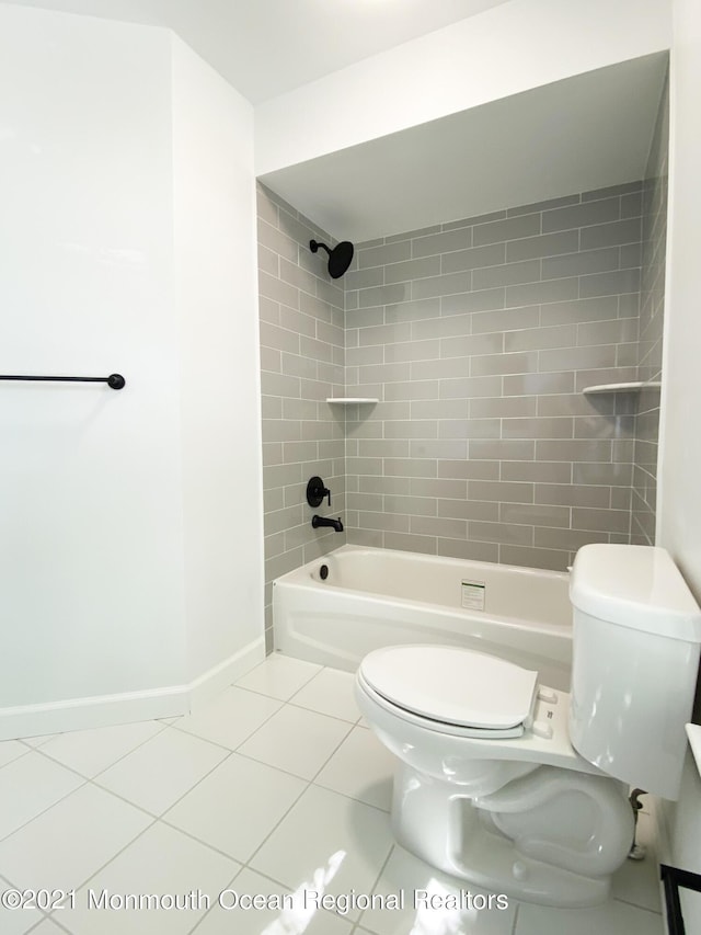 full bathroom with  shower combination, tile patterned flooring, toilet, and baseboards