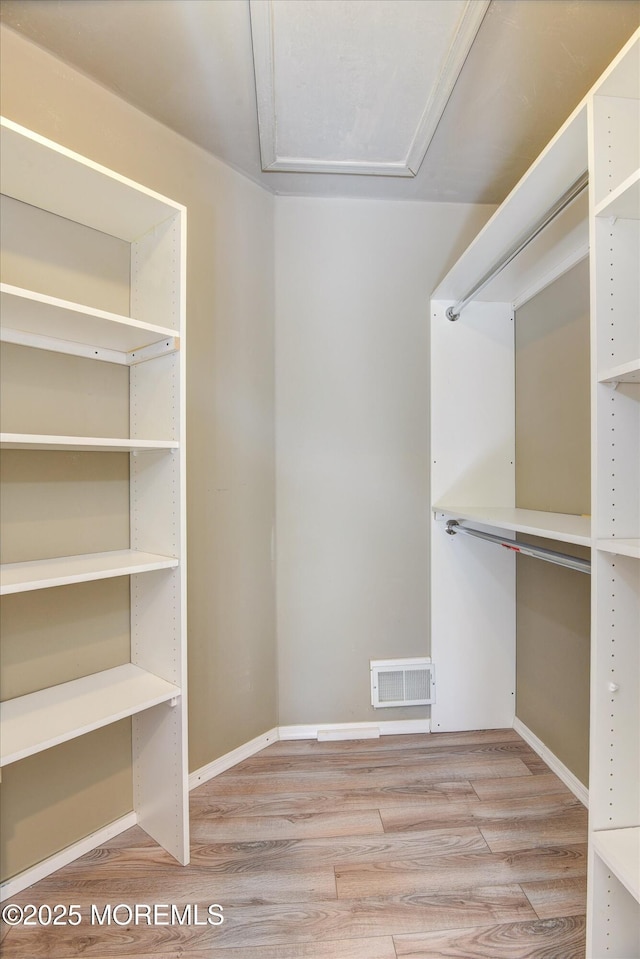 spacious closet with wood finished floors and visible vents