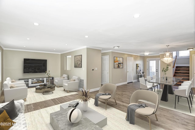 living room with baseboards, ornamental molding, wood finished floors, and recessed lighting