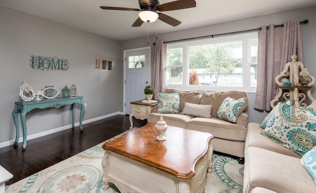 living area with a ceiling fan, baseboards, and wood finished floors