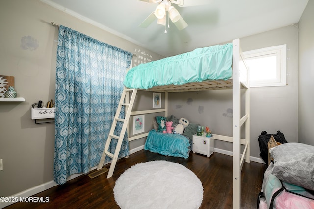 bedroom with ceiling fan, baseboards, and wood finished floors