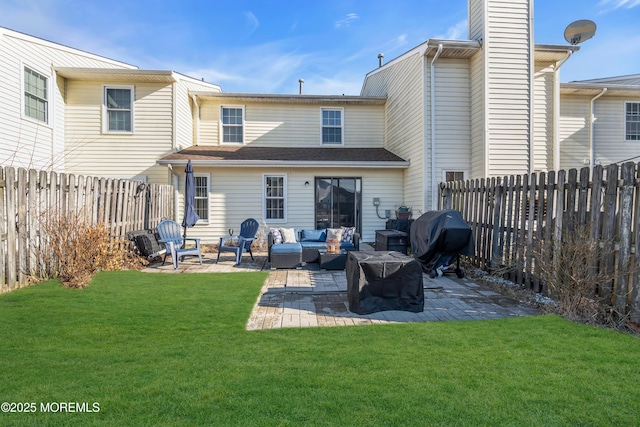 rear view of property with a yard, outdoor lounge area, a patio, and a fenced backyard