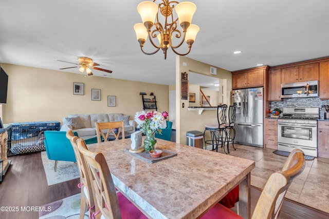 dining area featuring recessed lighting, wood finished floors, visible vents, and ceiling fan with notable chandelier