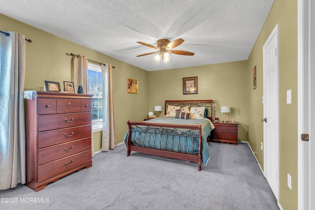 bedroom with carpet, ceiling fan, and a textured ceiling