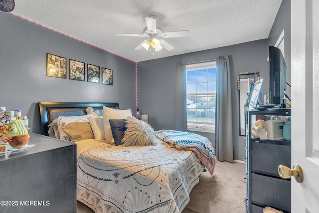 bedroom with carpet, ceiling fan, and a textured ceiling