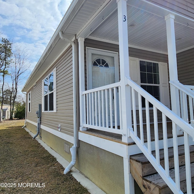 view of home's exterior featuring a porch and crawl space