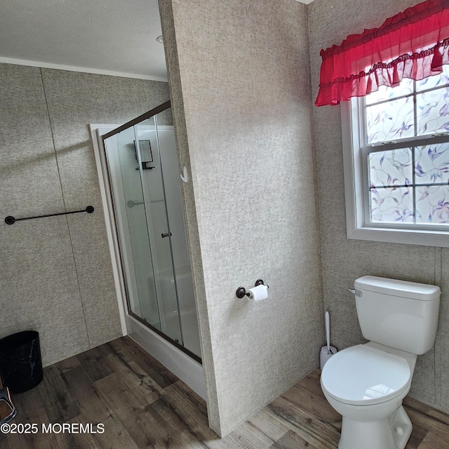 full bath with wood finished floors, toilet, and a shower stall