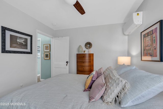 bedroom featuring ceiling fan and an AC wall unit