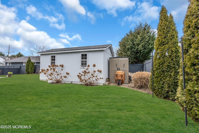 exterior space with an outbuilding, a fenced backyard, a yard, and a storage unit