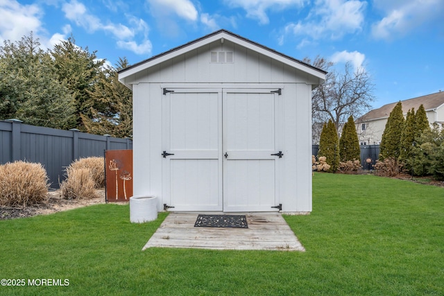 view of shed featuring fence