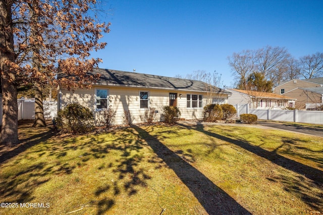 single story home with fence and a front yard