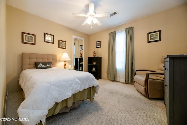 bedroom featuring carpet floors, visible vents, and a ceiling fan