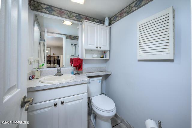 bathroom with toilet and vanity