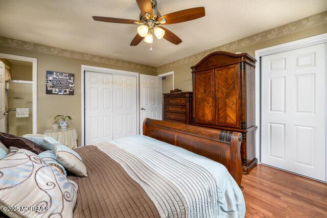 bedroom featuring ceiling fan, a closet, and light wood-style flooring