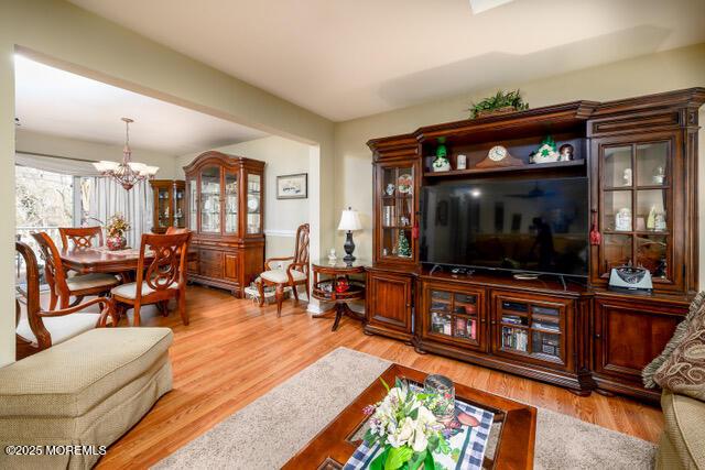 living area featuring a chandelier and light wood finished floors