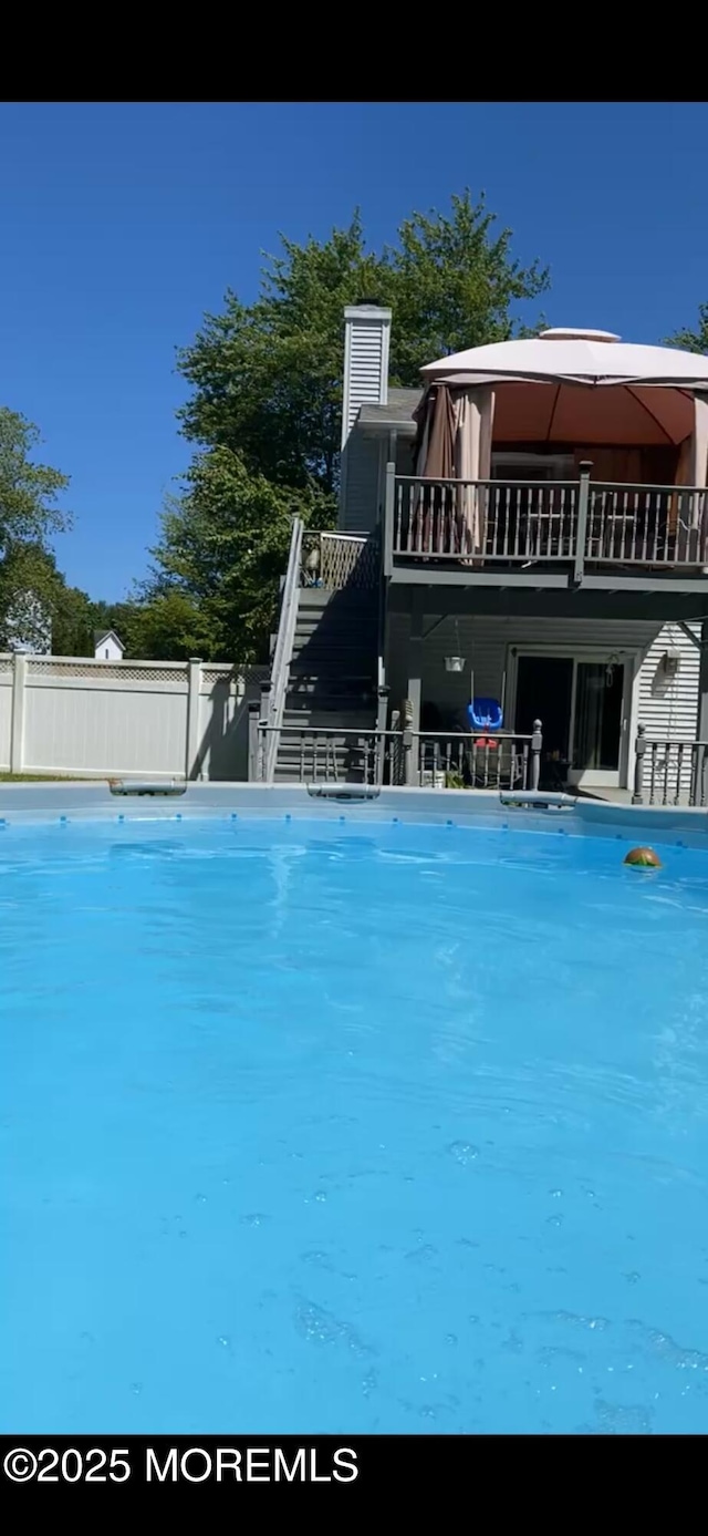 outdoor pool featuring stairway