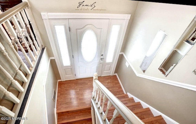 entryway featuring stairs, wood finished floors, and visible vents