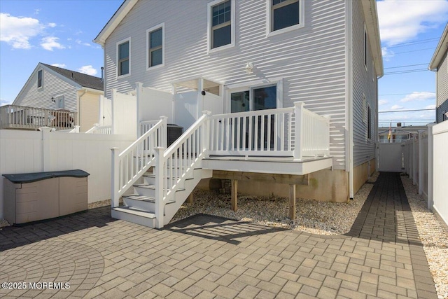 rear view of property with a patio area and a fenced backyard