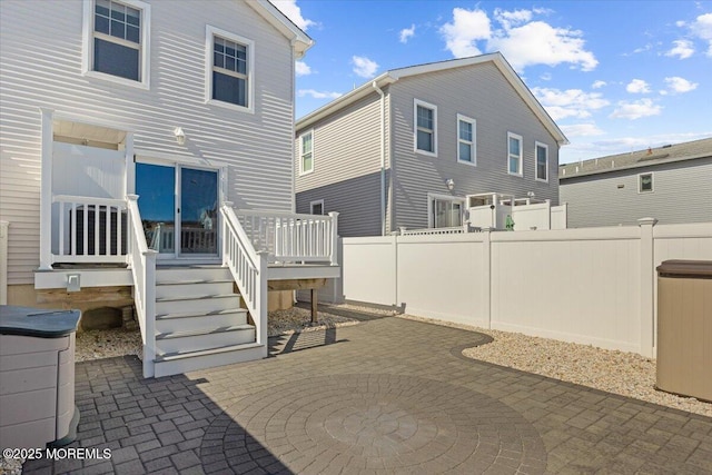 back of property with a deck, a patio, and fence private yard