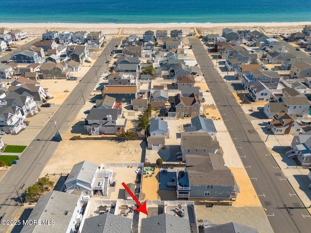 birds eye view of property with a residential view, a beach view, and a water view