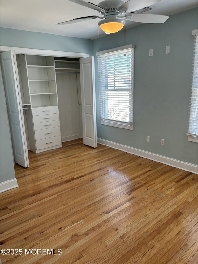 unfurnished bedroom featuring a closet, baseboards, and light wood-style floors