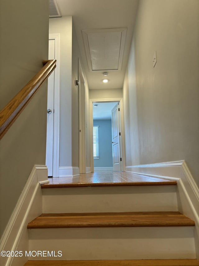 stairway with attic access and visible vents