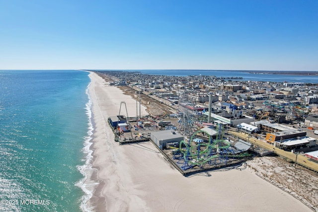 aerial view with a water view and a view of the beach