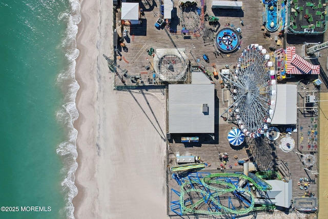 bird's eye view with a water view and a beach view