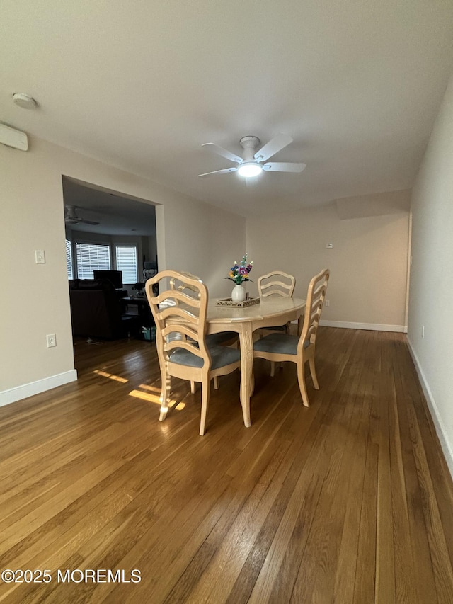 dining space featuring hardwood / wood-style flooring, baseboards, and a ceiling fan