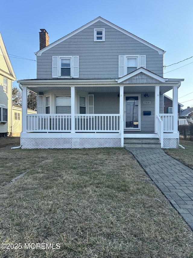 view of front of house featuring covered porch and a front yard