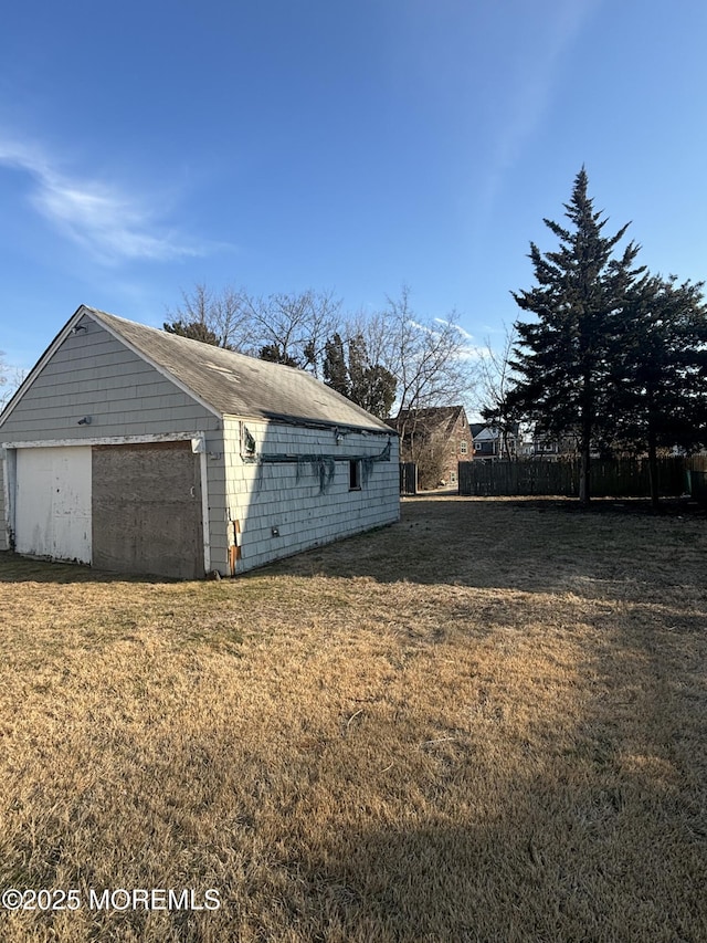 view of home's exterior featuring a yard and a detached garage