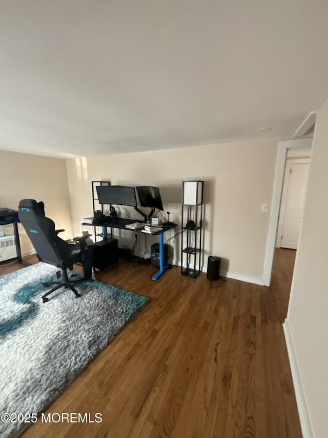 office area featuring baseboards and wood finished floors