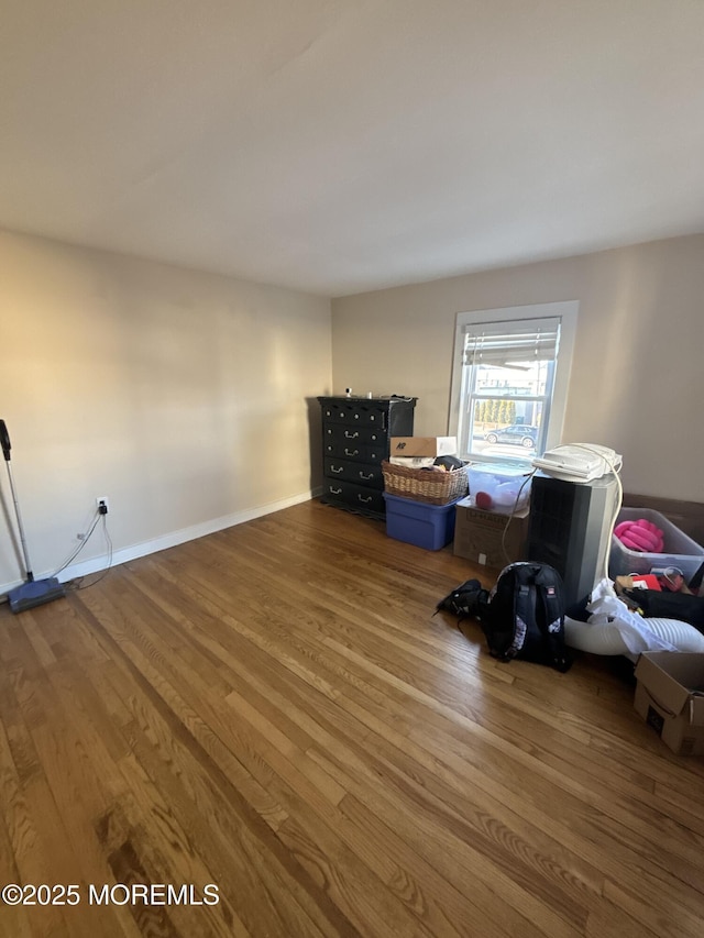 interior space with baseboards and wood finished floors