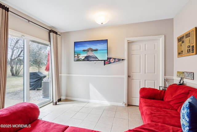 living area featuring baseboards and light tile patterned flooring