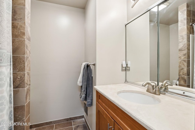 full bath with a shower with shower curtain, vanity, and tile patterned floors