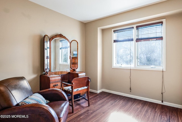 living area with baseboards and dark wood-style flooring