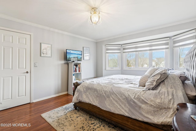 bedroom featuring ornamental molding, baseboards, and wood finished floors