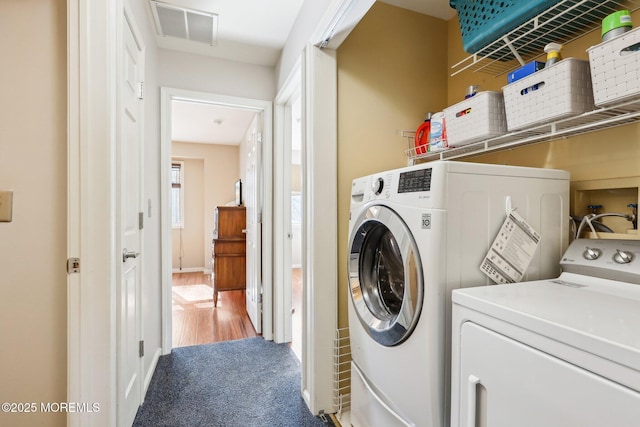 laundry room featuring laundry area, carpet floors, visible vents, and washer and dryer