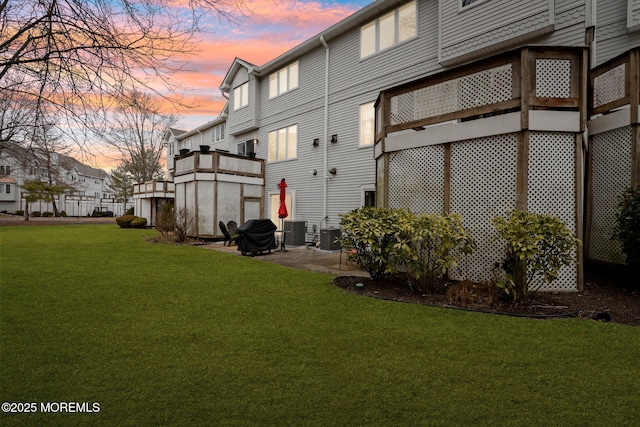 exterior space featuring a patio, a lawn, and cooling unit