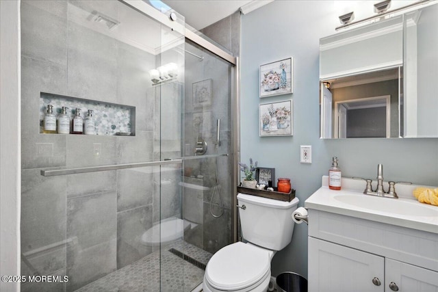 bathroom featuring toilet, a stall shower, visible vents, and vanity