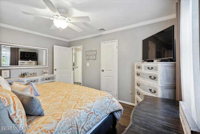 bedroom featuring ceiling fan, dark wood-style flooring, visible vents, baseboards, and crown molding