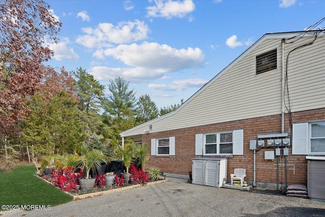 view of side of property featuring brick siding